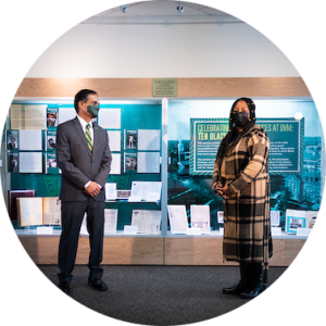 Dr. Wanda Heading-Grant and President Garimella stand in front of display case