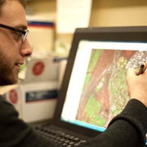 Person working on a map on computer