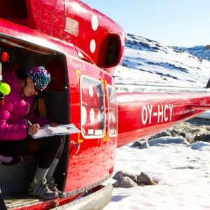 A PhD student studying the environment from a helicopter in Greenland from the Gund Institute for Environment at the University of Vermont.