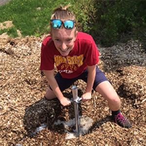 Graduate student uses soil core in chip pile