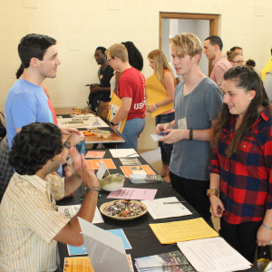 Students asking and answering questions at a resource fair.