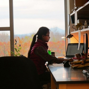 Student working at a desk for an internship.