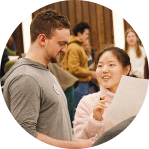 Male Orientation Leader helping a new student with activity