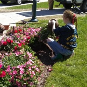 student planting flowers