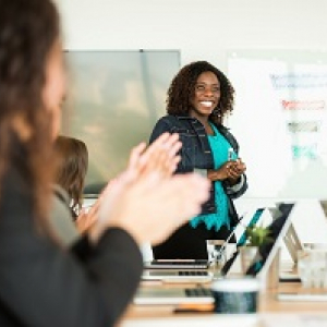 Person smiling during their presentation to a class.