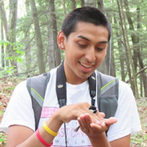 Student holding chickadee
