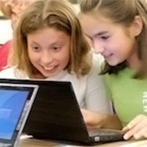 Young children excited around a computer Young children excited around a computer