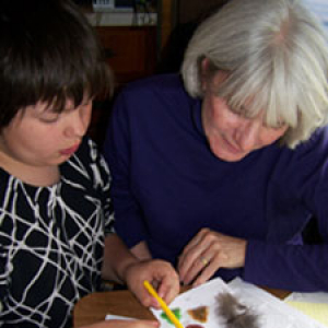 A teacher assisting a student with their school work.
