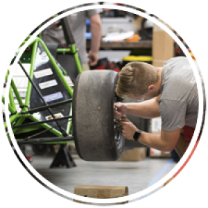 student in AERO putting on a wheel
