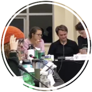 senators at a table during their weekly meeting