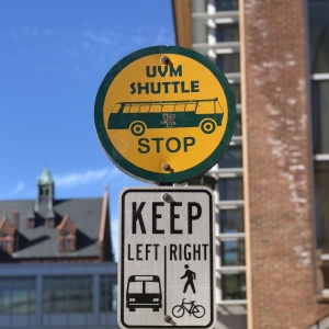 a uvm bus stop sign