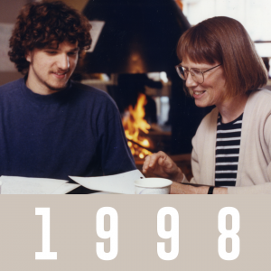 Sue Dinitz sits at a table with student Anothony Eguzi in 1999. She gestures at a piece of paper on the table.