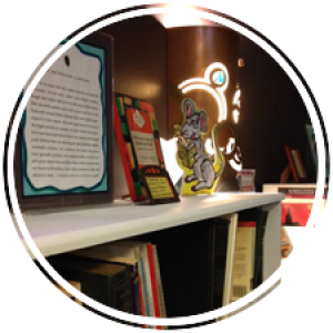 books, photos, poems, lights, awards, and notes line the bookshelves of the book nook