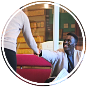 a student shaking hands with an advisor in the career center