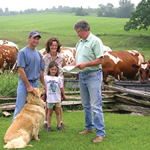 Family, dog, cows, farm field