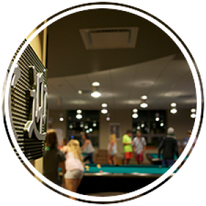 welcome signs in different languages on the wall with pool tables in the background
