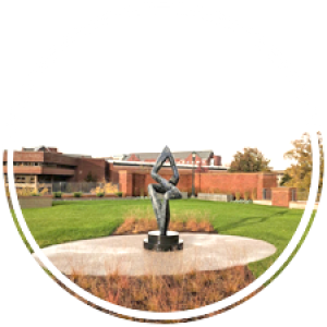 a narrow marble sculpture sits in the center of a grassy area on the green roof
