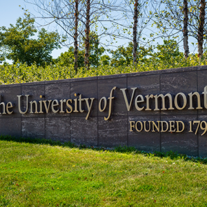 Large granite sign reading "The University of Vermont" 