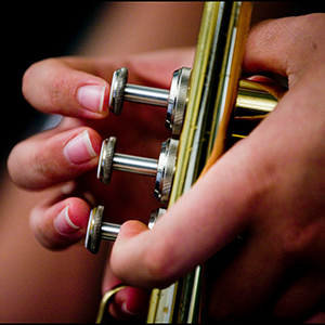 close-up of hands playing keys on an instrument