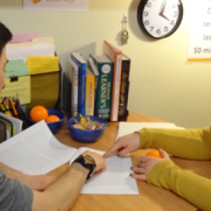 The UVM Writing Centers Writing Center tutor reviews a written draft with student.