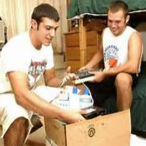 2 male students unpacking in their room