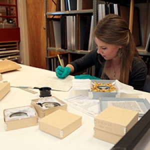 Student researching object in storage