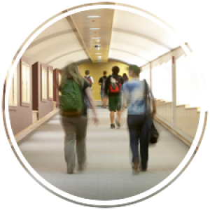 students walk down a long tunnel that runs underground