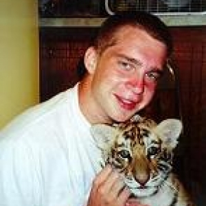 Student holding a tiger cub