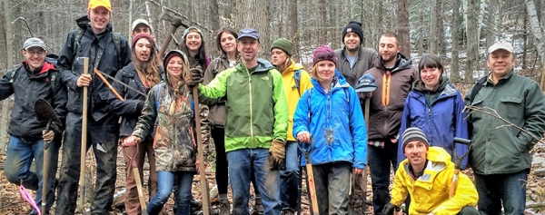 Group of students and faculty in the woods
