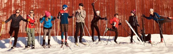 Nordic skiers next to barn. Photo credit: Kingdom Trails Association
