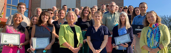 Group of faculty and staff outside Aiken Center building