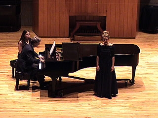 A vocalist performs with piano accompaniment