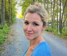 Jean Bessette, looking into camera, blond hair up in a bun