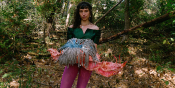 Outdoor shot holding colorful art piece