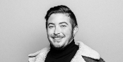 Black and White headshot of a smiling Jaimes against a neutral background