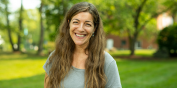 Image of a happy, smiling Julia on a sunny day on the UVM Green