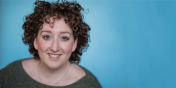 Carly Schneider smiles in front of bright blue backdrop