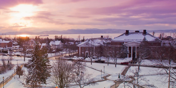 A pink and purple sunset view on the snowy UVM campus