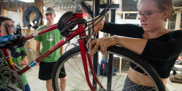woman repairing a bike
