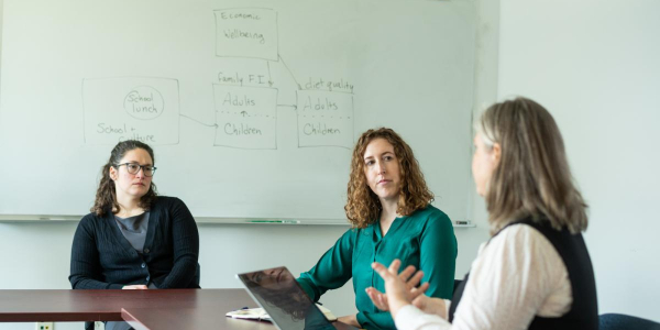 Researchers Ashley McCarthy and Farryl Bertmann discuss their research on COVID and food security as another researcher looks on