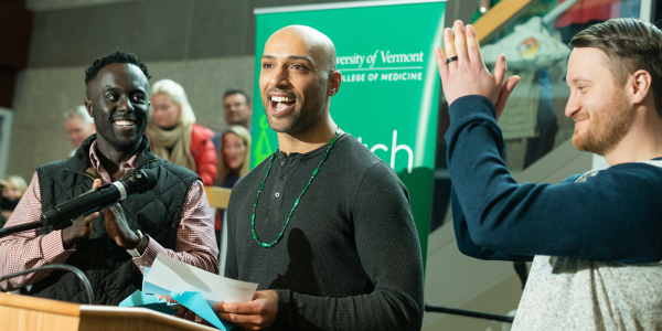 A medical student stands at a podium and reads his match letter