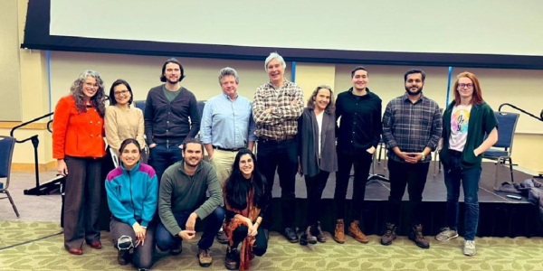 A group of faculty and event organizers posed together in the Davis Center at UVM at the Rethinking Economics event