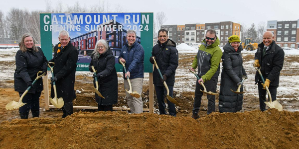 UVM officials pose with ceremonial shovels in front of the future site of Catamount Run