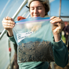 woman holding bag of soil
