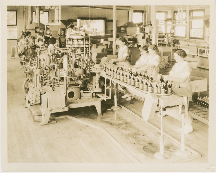 Employees packing bottles of Vermont Maid Syrup