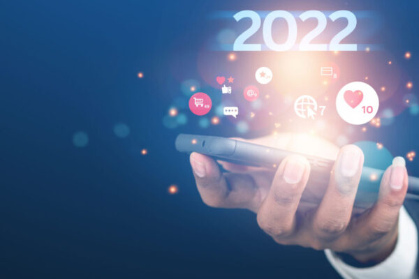 2022 marketing graphic with a hand holding a mobile device